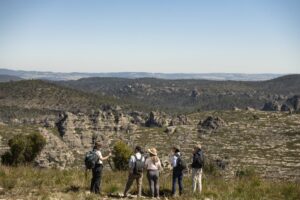 Wolgan Valley Eco Tour guests listening to our guide with the rock pagodas of Lost City in the background