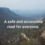 Panoramic views over Wolgan Valley with 'A safe and accessible road for everyone' text across the screen.